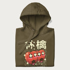 Folded military green hoodie with Japanese graphic of two cute apples with kawaii faces, surrounded by the Japanese text '林檎' (Apple)