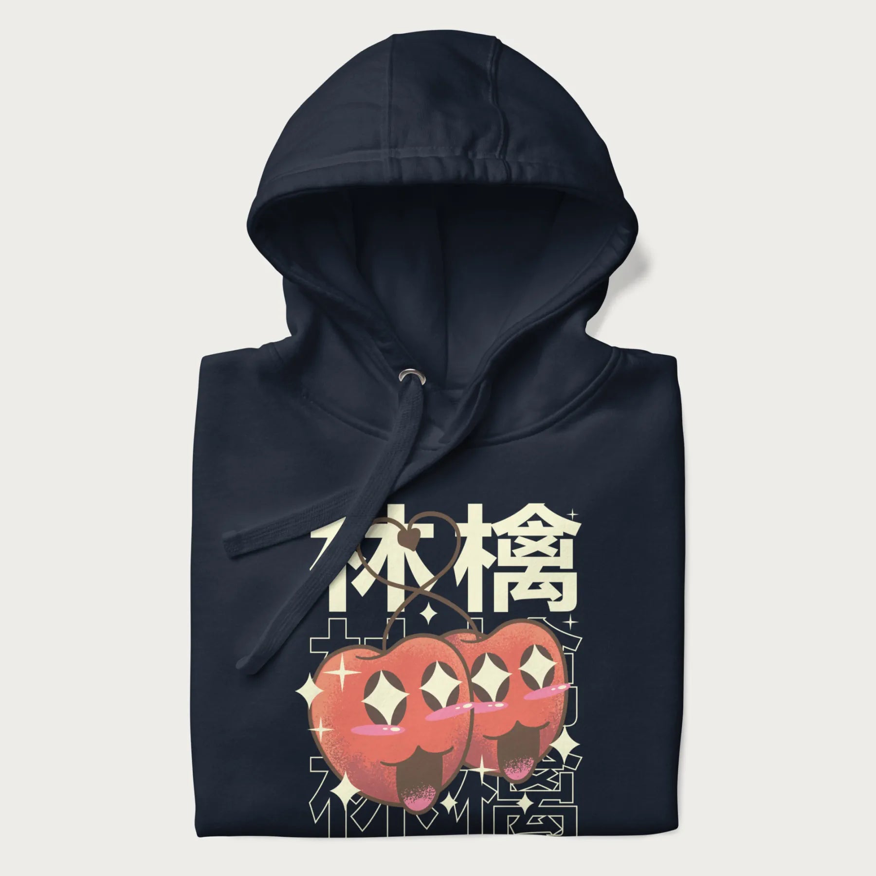 Folded navy blue hoodie with Japanese graphic of two cute apples with kawaii faces, surrounded by the Japanese text '林檎' (Apple)