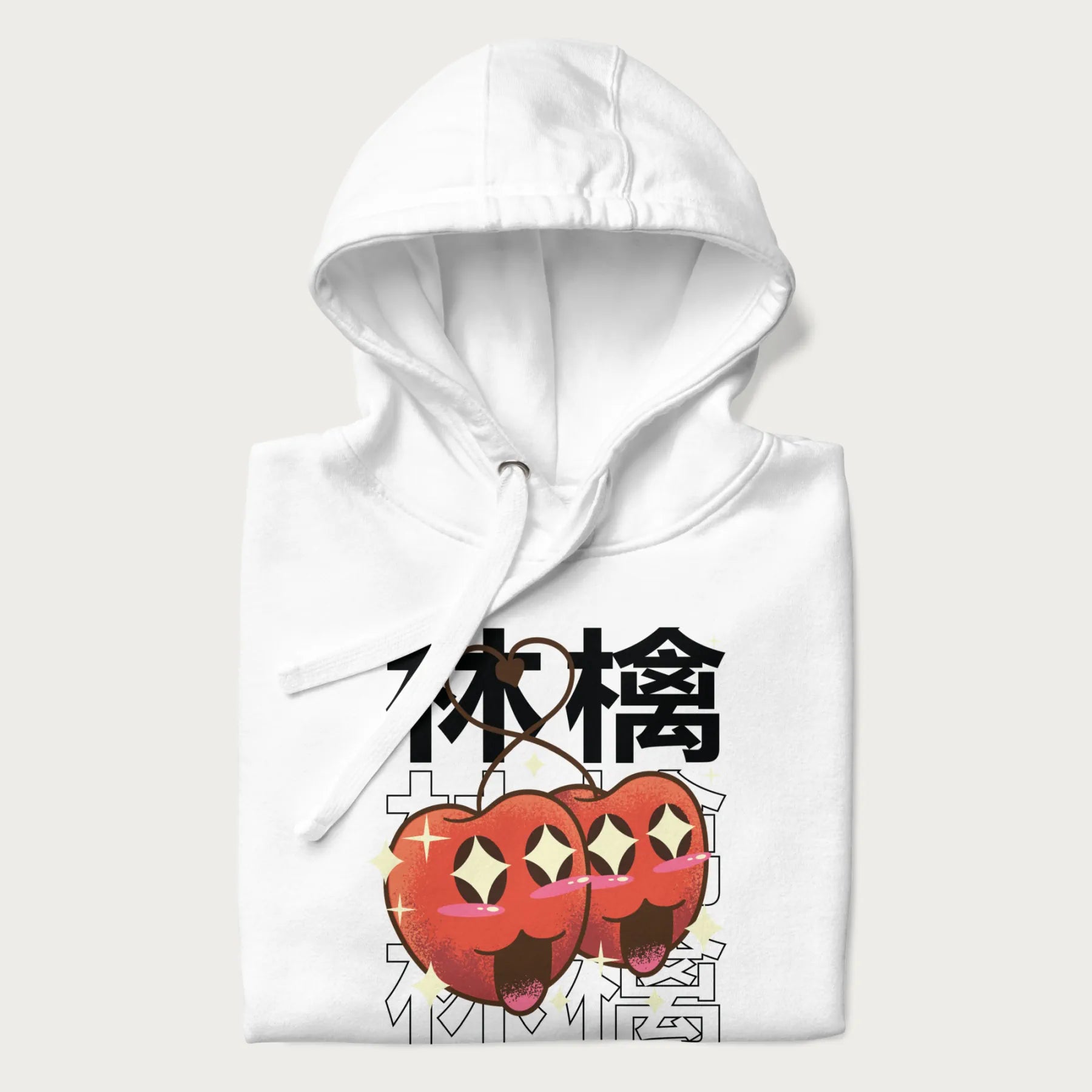 Folded white hoodie with Japanese graphic of two cute apples with kawaii faces, surrounded by the Japanese text '林檎' (Apple)