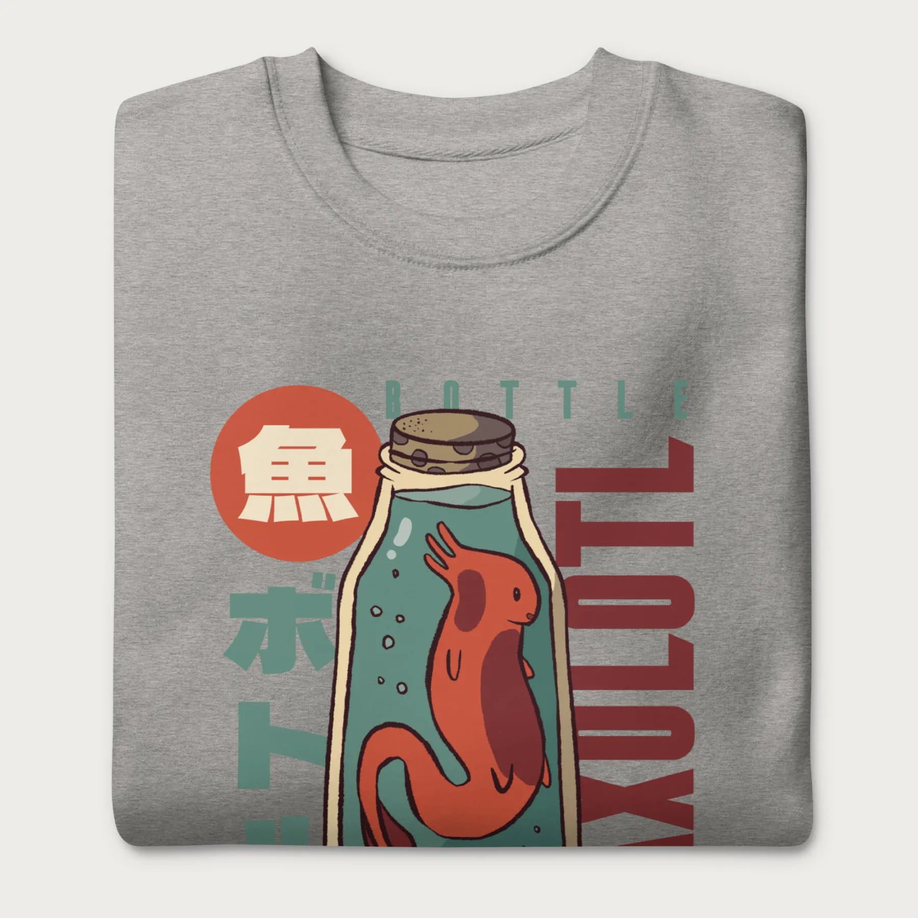 Folded light grey sweatshirt with a vintage graphic of an axolotl in a glass bottle with bold Japanese text.