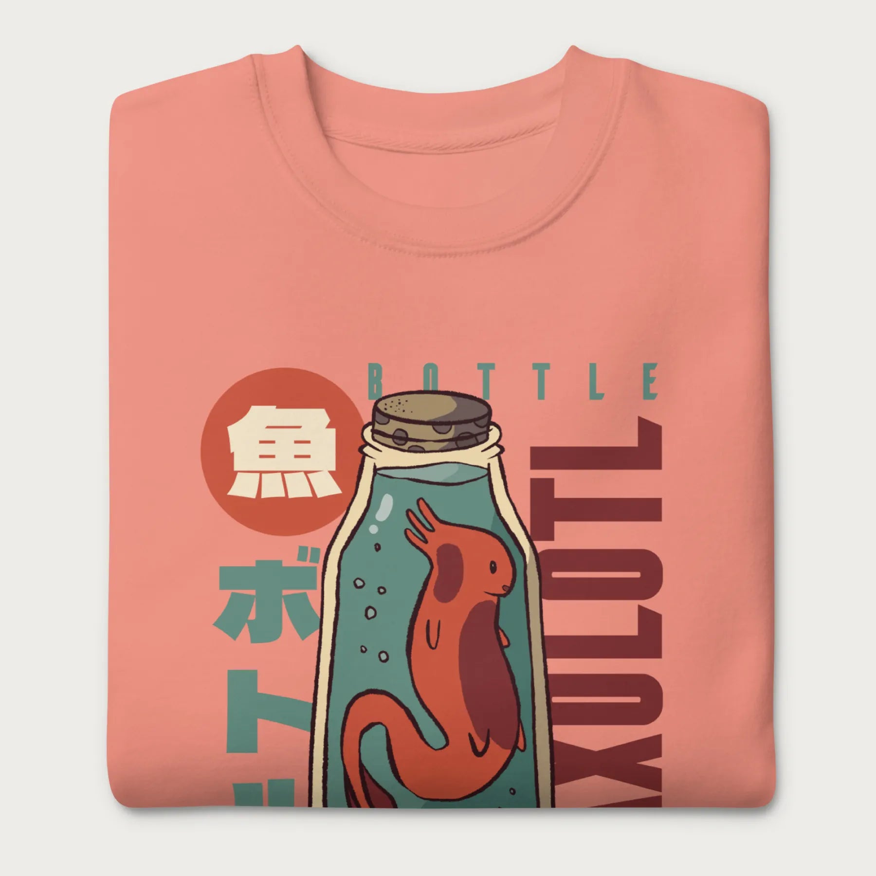 Folded light pink sweatshirt with a vintage graphic of an axolotl in a glass bottle with bold Japanese text.