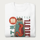 Folded white sweatshirt with a vintage graphic of an axolotl in a glass bottle with bold Japanese text.