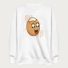 White sweatshirt with Japanese text and a kawaii boiled egg graphic with sparkling eyes..