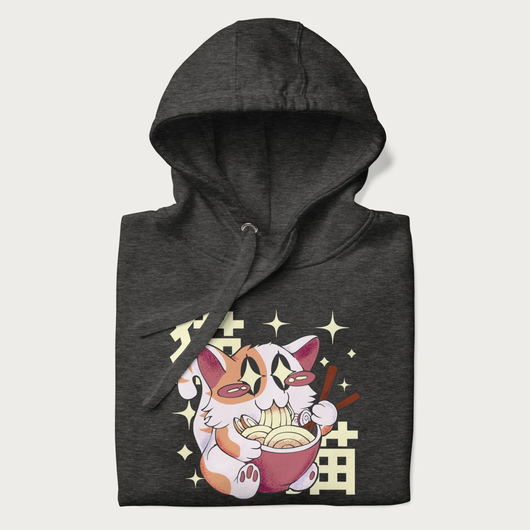 Folded dark grey hoodie with Japanese graphic of a cat eating ramen with Japanese text '猫' in the background.