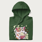 Folded forest green hoodie with Japanese graphic of a cat eating ramen with Japanese text '猫' in the background.