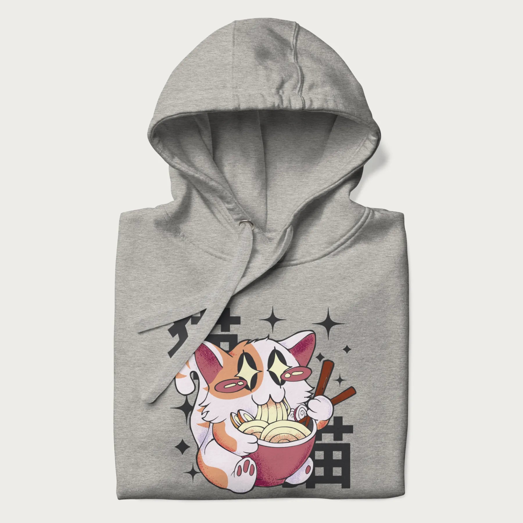 Folded light grey hoodie with Japanese graphic of a cat eating ramen with Japanese text '猫' in the background.