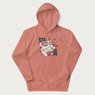 Light pink hoodie with Japanese graphic of a cat eating ramen with Japanese text '猫' in the background.