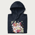 Folded navy blue hoodie with Japanese graphic of a cat eating ramen with Japanese text '猫' in the background.
