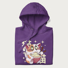 Folded purple hoodie with Japanese graphic of a cat eating ramen with Japanese text '猫' in the background.