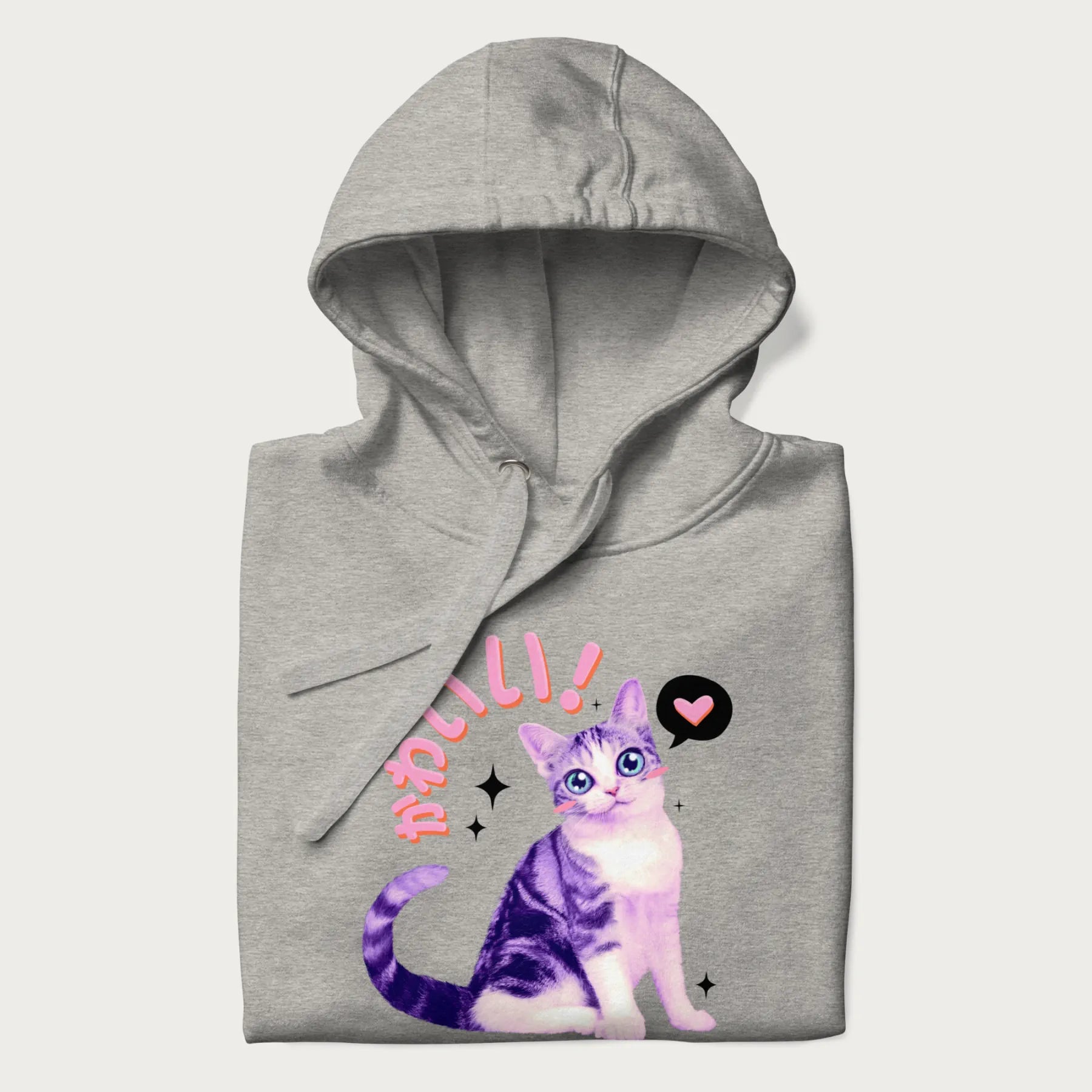 Folded light grey hoodie with a graphic of a blue-eyed kitten and Japanese kawaii-style lettering, stars, and a heart.