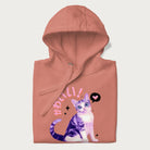Folded light pink hoodie with a graphic of a blue-eyed kitten and Japanese kawaii-style lettering, stars, and a heart.