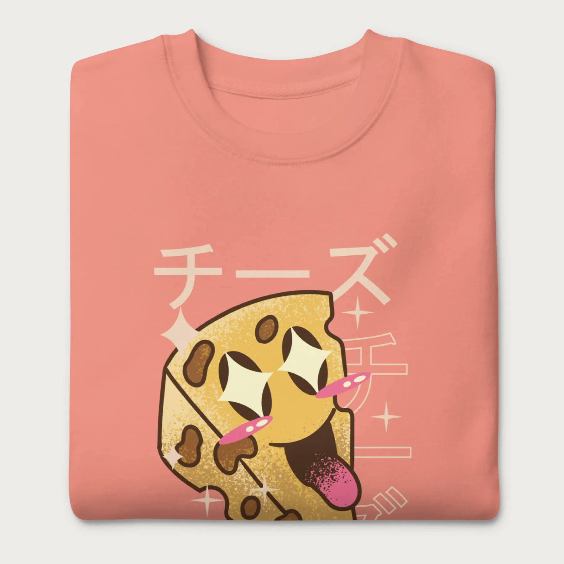 Folded light pink sweatshirt with Japanese text and a kawaii cheese wedge graphic.