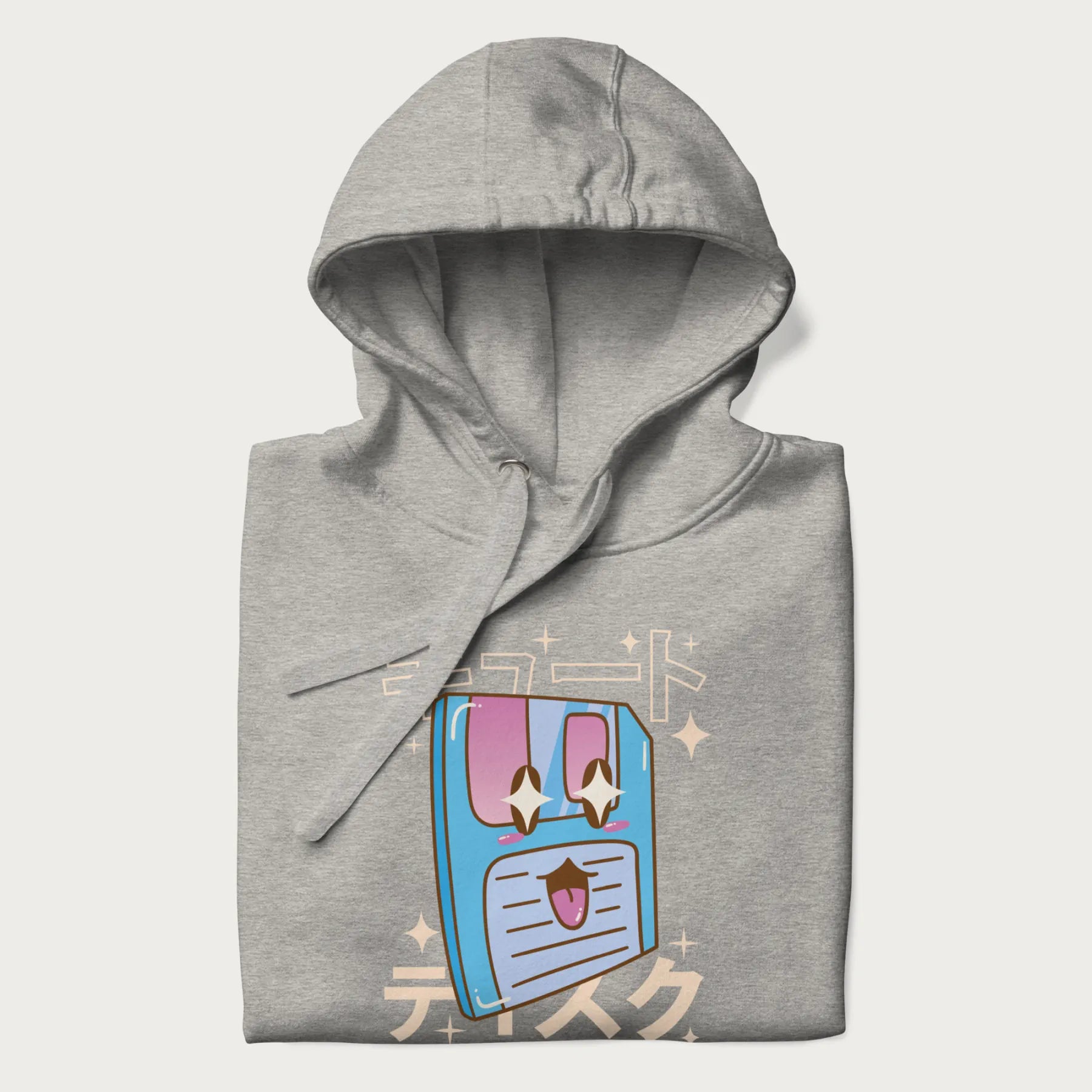 Folded light grey hoodie with Japanese graphic of a cute sky-blue floppy disk with Japanese text 'キュート' (Cute) and 'ティスク' (Disk).