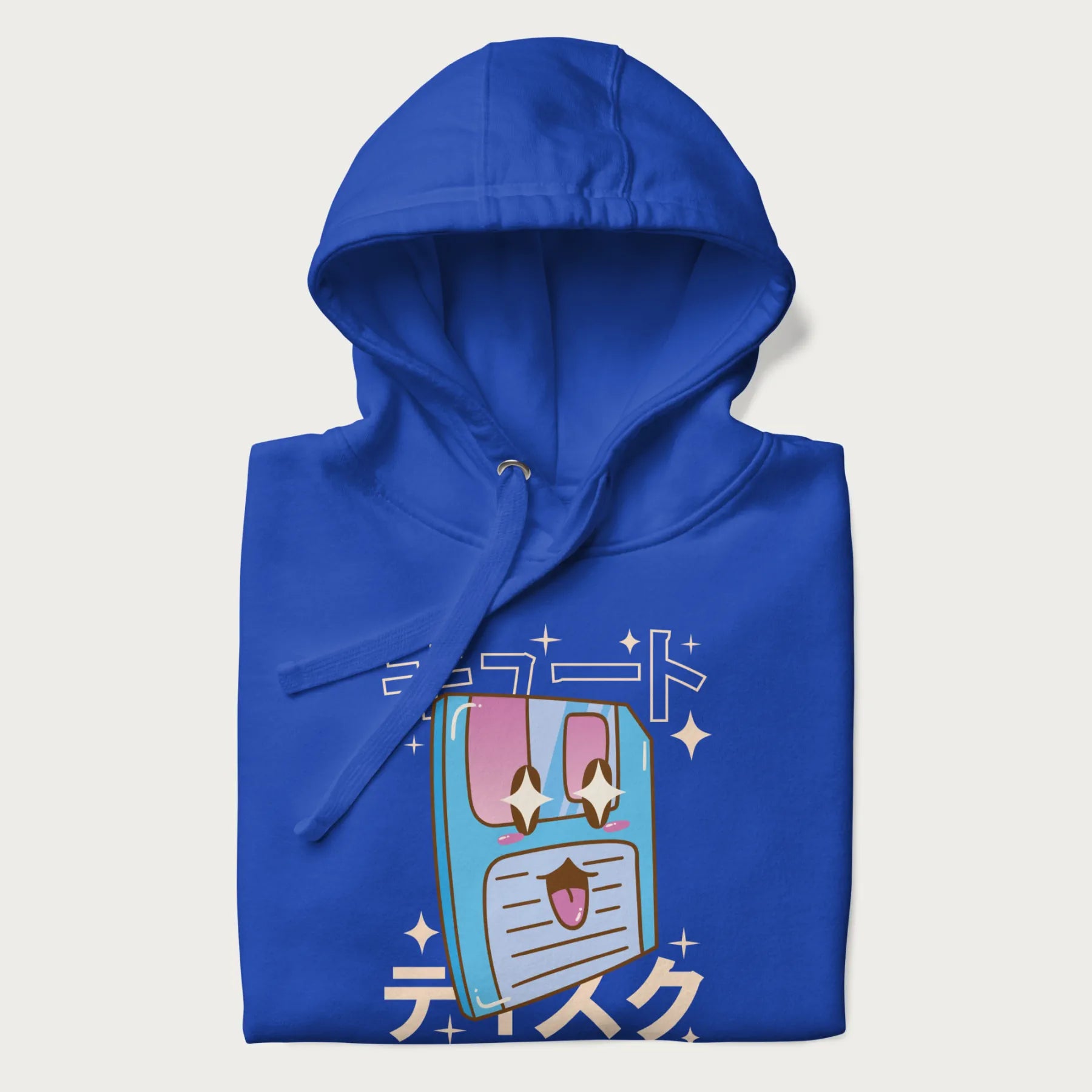 Folded royal blue hoodie with Japanese graphic of a cute sky-blue floppy disk with Japanese text 'キュート' (Cute) and 'ティスク' (Disk).