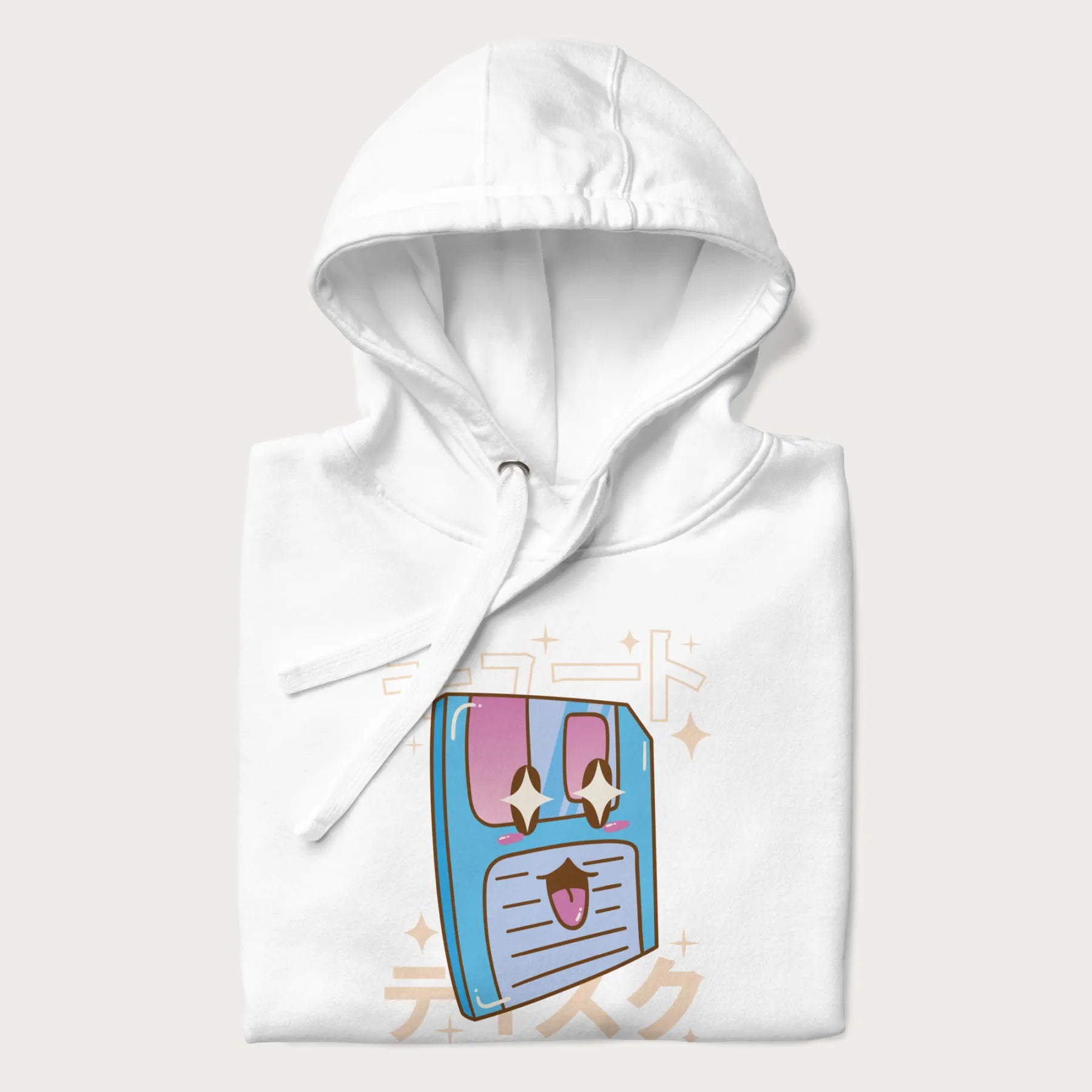 Folded white hoodie with Japanese graphic of a cute sky-blue floppy disk with Japanese text 'キュート' (Cute) and 'ティスク' (Disk).