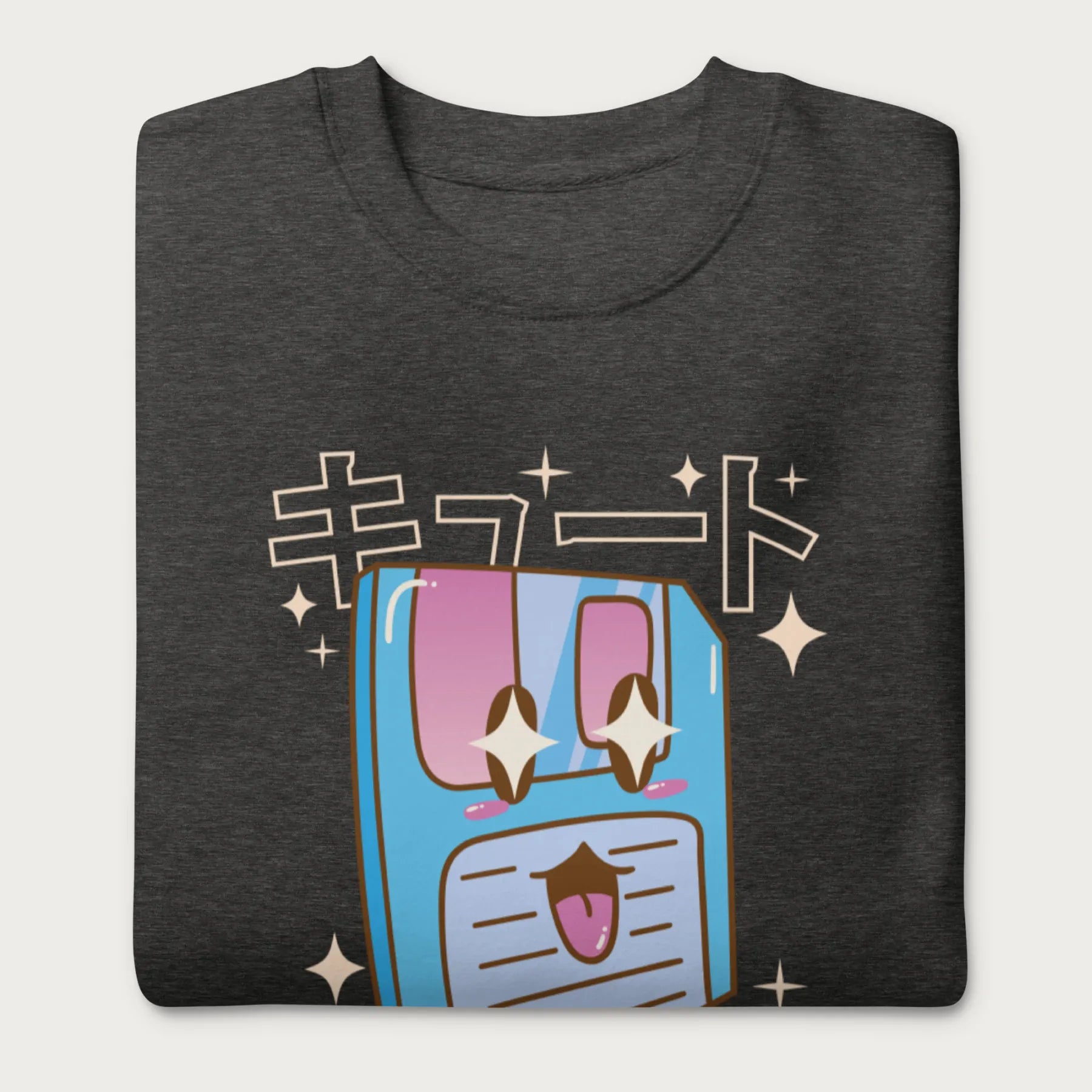 Folded dark grey sweatshirt with a kawaii floppy disk graphic in vibrant colors and Japanese text.