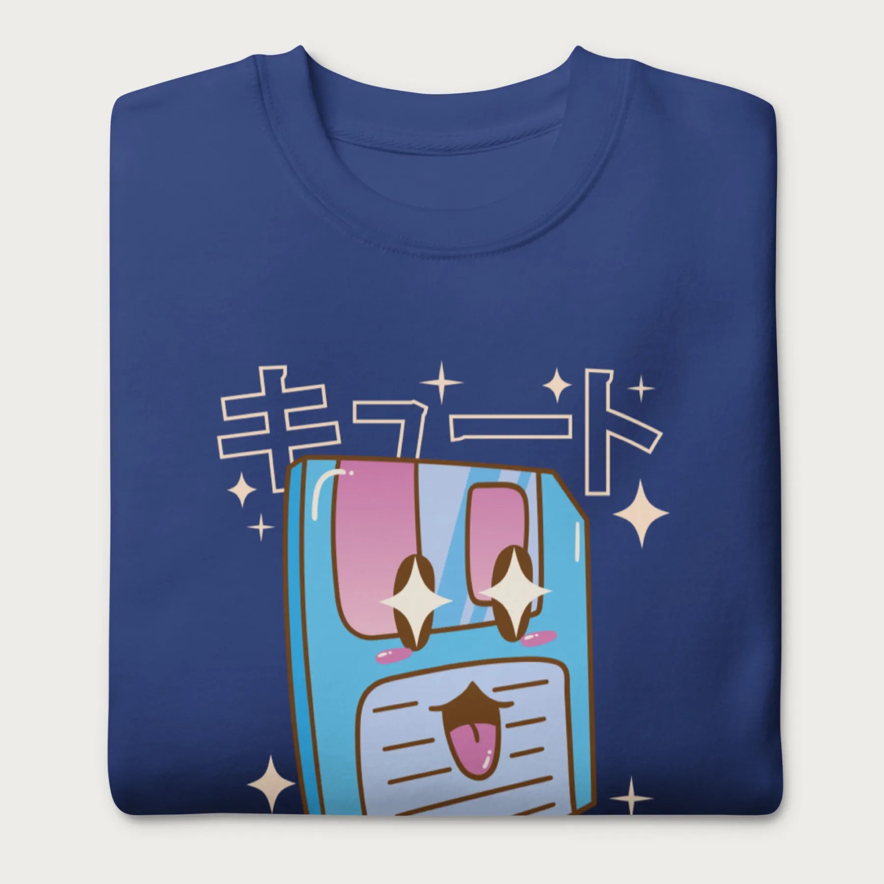 Folded royal blue sweatshirt with a kawaii floppy disk graphic in vibrant colors and Japanese text.