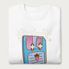 Folded white sweatshirt with a kawaii floppy disk graphic in vibrant colors and Japanese text.