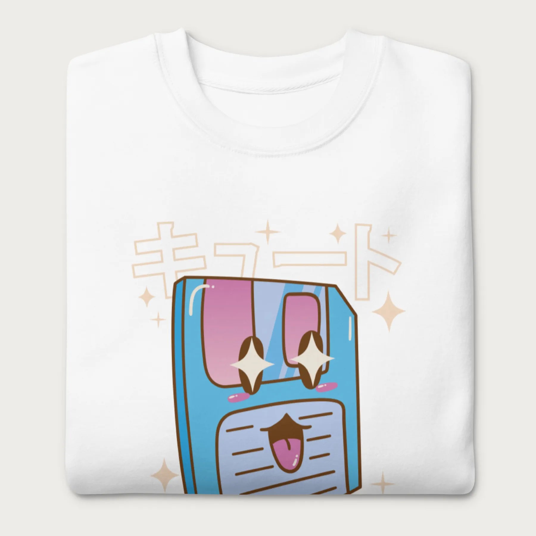 Folded white sweatshirt with a kawaii floppy disk graphic in vibrant colors and Japanese text.