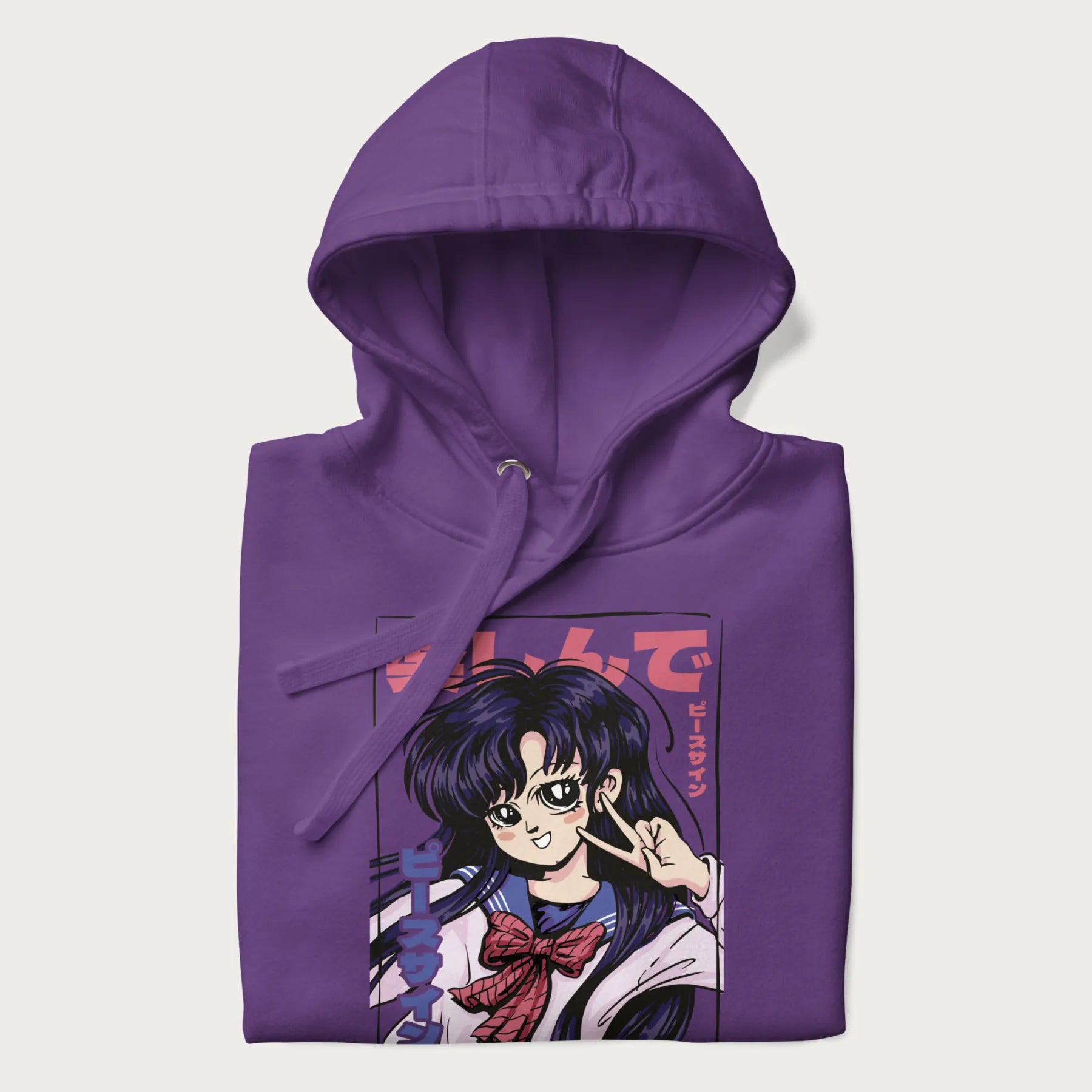 Folded purple hoodie with Japanese graphic of an anime girl making a peace sign, with Japanese text '楽しんで' (Enjoy) and 'ピースサイン' (Peace Sign).