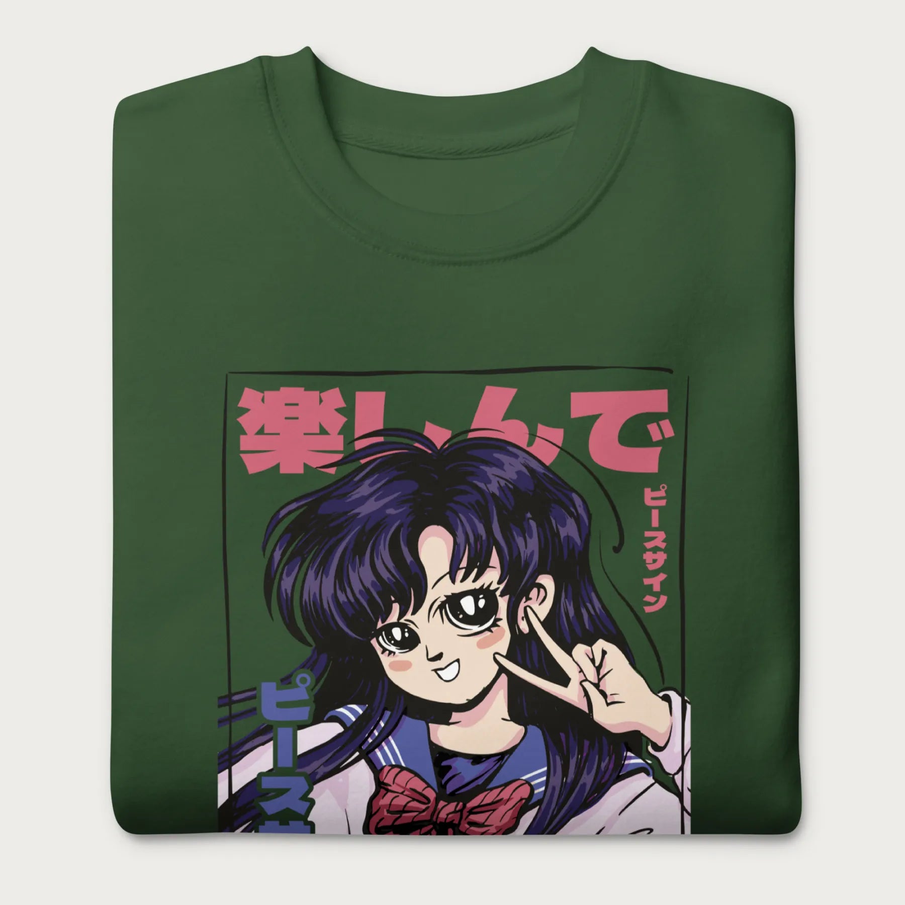 Folded forest green sweatshirt with a vibrant graphic of an anime girl flashing a peace sign with bold Japanese text.