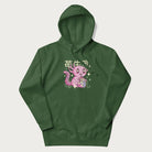 Forest green hoodie with Japanese graphic of a cute pink axolotl sipping strawberry milk from a carton, with Japanese text '苺牛乳' (Strawberry Milk).