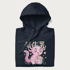 Folded navy blue hoodie with Japanese graphic of a cute pink axolotl sipping strawberry milk from a carton, with Japanese text '苺牛乳' (Strawberry Milk).