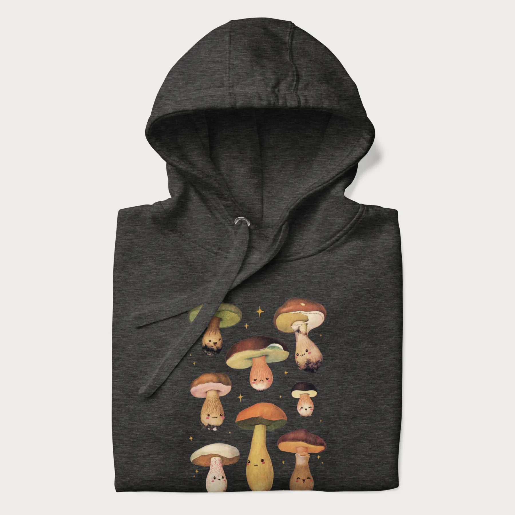 Folded dark grey hoodie with Japanese graphic of cute and expressive mushrooms with various faces.