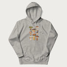 Light grey hoodie with Japanese graphic of cute and expressive mushrooms with various faces.