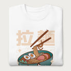 Folded white sweatshirt with Japanese text and a kawaii ramen bowl graphic.