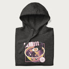 Folded dark grey hoodie with Japanese text '拉麵!!!' (Ramen!!!) in vibrant pink and realistic ramen bowl graphic.