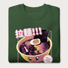 Folded forest green sweatshirt with Japanese text and a kawaii ramen bowl graphic.