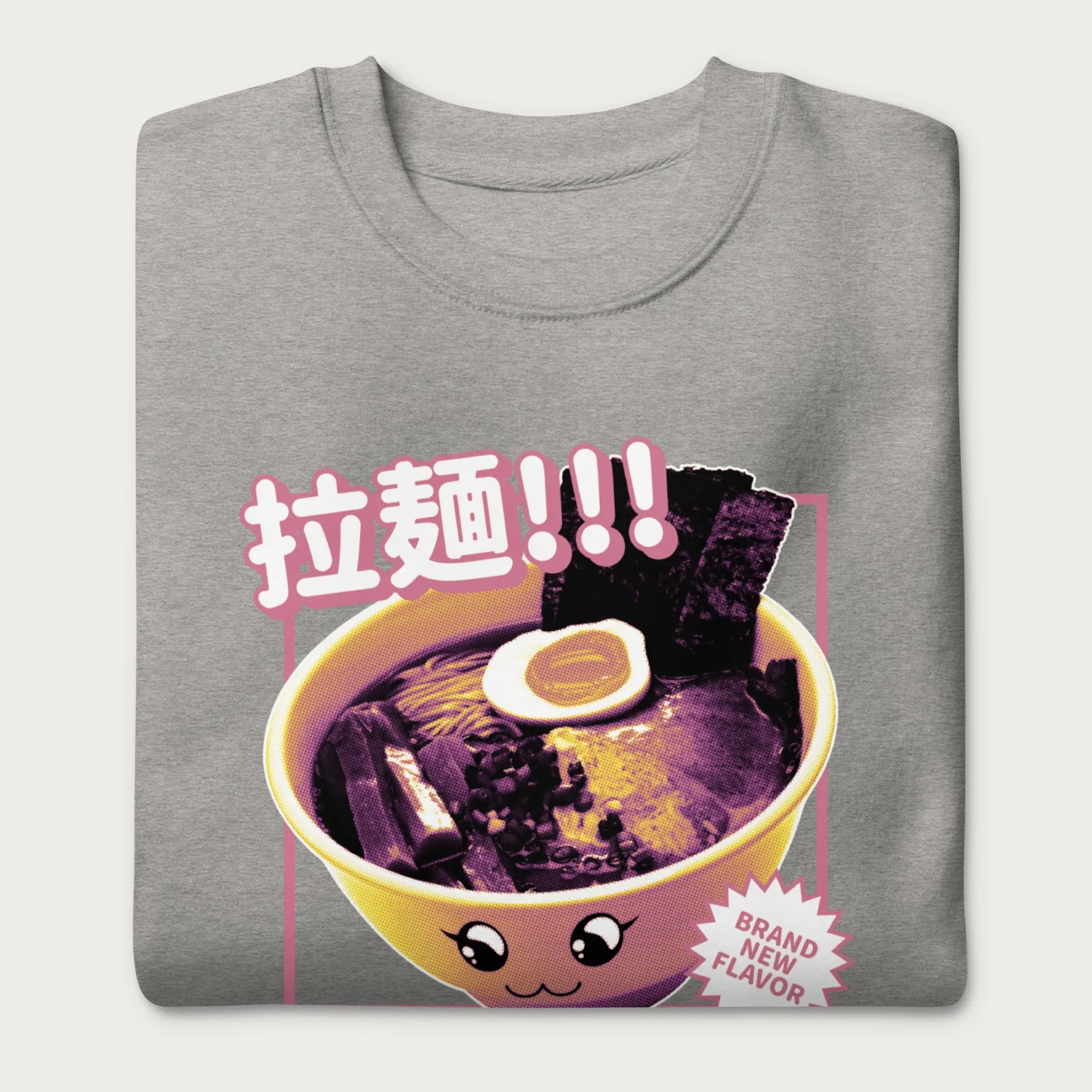 Folded light grey sweatshirt with Japanese text and a kawaii ramen bowl graphic.