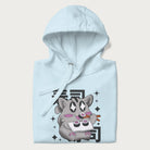 Folded light blue hoodie with Japanese graphic of a cute grey cat eating sushi, with the Japanese text '寿司' (Sushi) in the background.