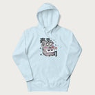 Light blue hoodie with Japanese graphic of a cute grey cat eating sushi, with the Japanese text '寿司' (Sushi) in the background.