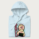 Folded light blue hoodie featuring a cute sushi and onigiri graphic with the text "Kawaii Sushi Club", colorful neon accents and Japanese characters.