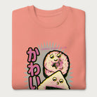 Folded light pink sweatshirt with a cute graphic of a sushi roll and onigiri, featuring the Japanese text 'Kawaii.'