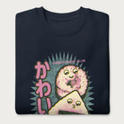 Folded navy blue sweatshirt with a cute graphic of a sushi roll and onigiri, featuring the Japanese text 'Kawaii.'