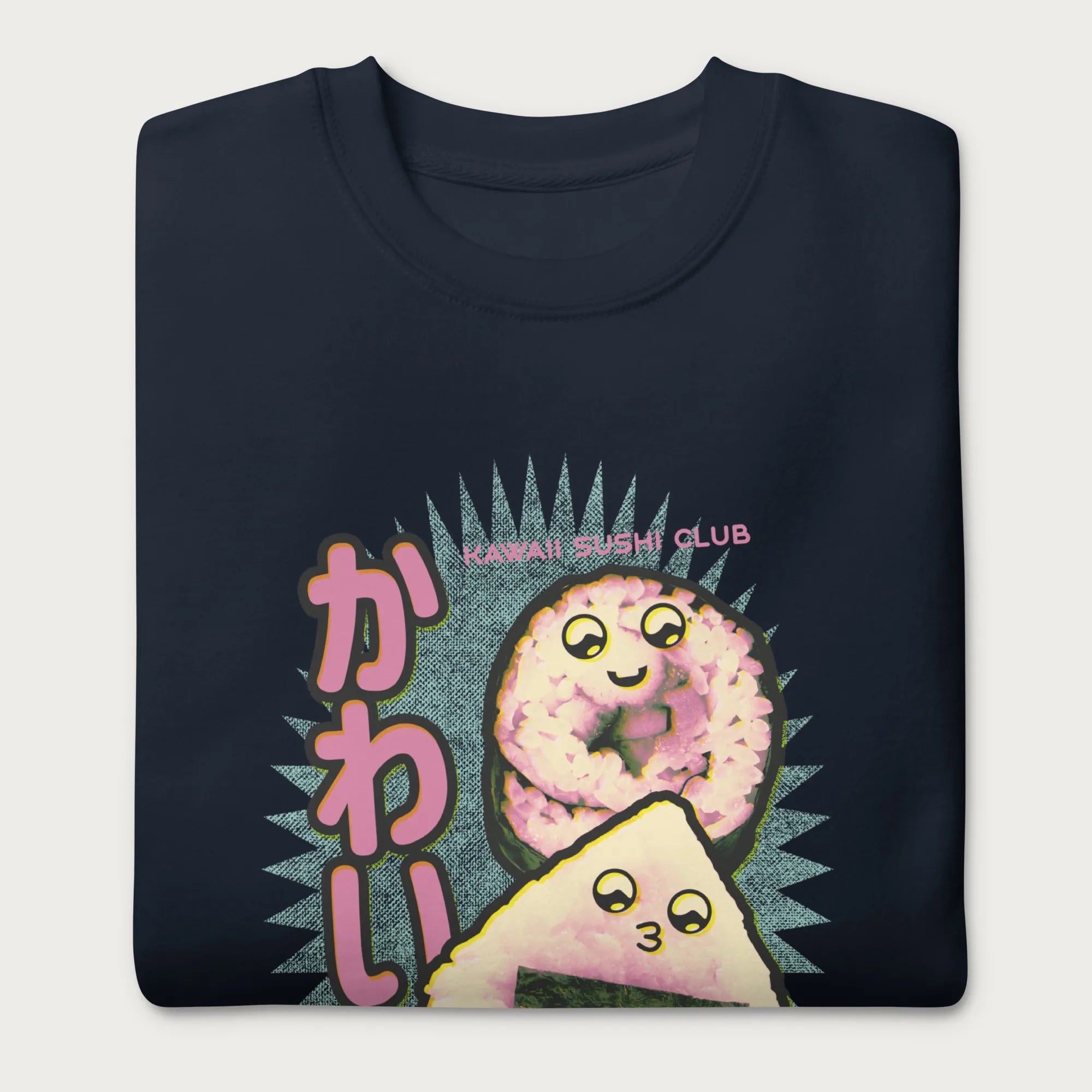 Folded navy blue sweatshirt with a cute graphic of a sushi roll and onigiri, featuring the Japanese text 'Kawaii.'