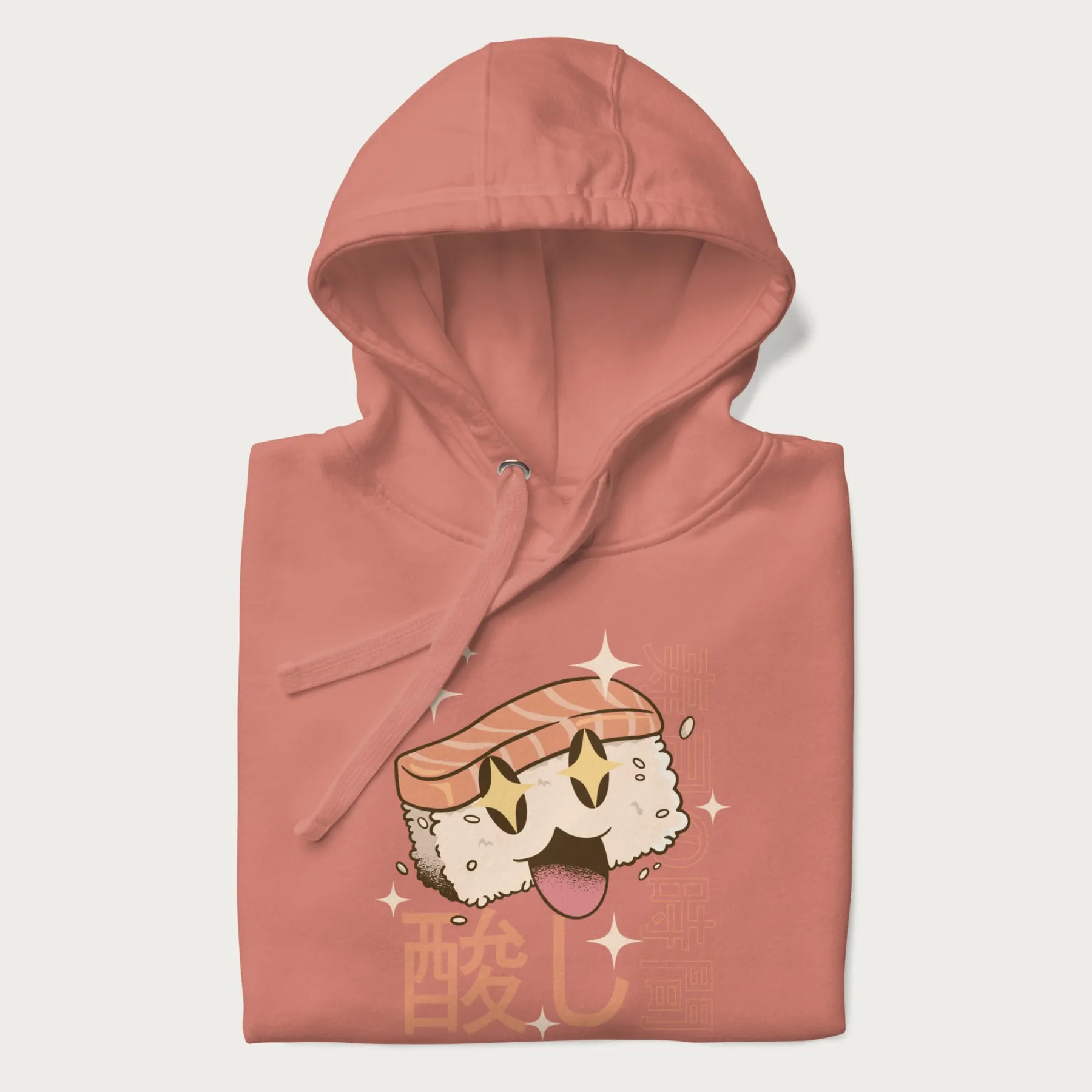 Folded light pink hoodie with Japanese graphic of a cute sushi with sparkling eyes accompanied by Japanese text '寿司の時間' (Sushi Time).