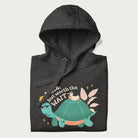 Folded dark grey hoodie with graphic of a turtle and duck with sunglasses and the text 'Late but Worth the Wait'.