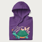 Folded purple hoodie with graphic of a turtle and duck with sunglasses and the text 'Late but Worth the Wait'.