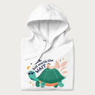 Folded white hoodie with graphic of a turtle and duck with sunglasses and the text 'Late but Worth the Wait'.