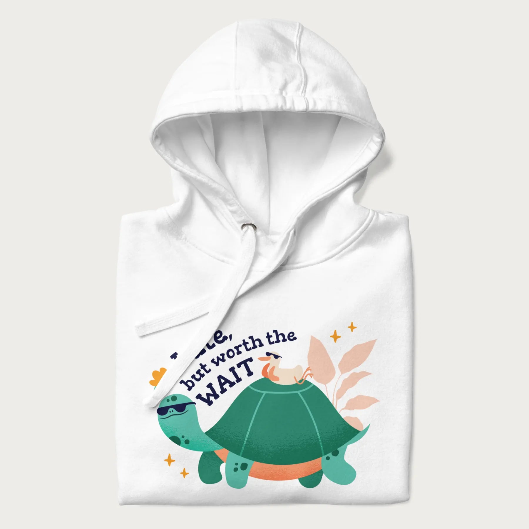 Folded white hoodie with graphic of a turtle and duck with sunglasses and the text 'Late but Worth the Wait'.