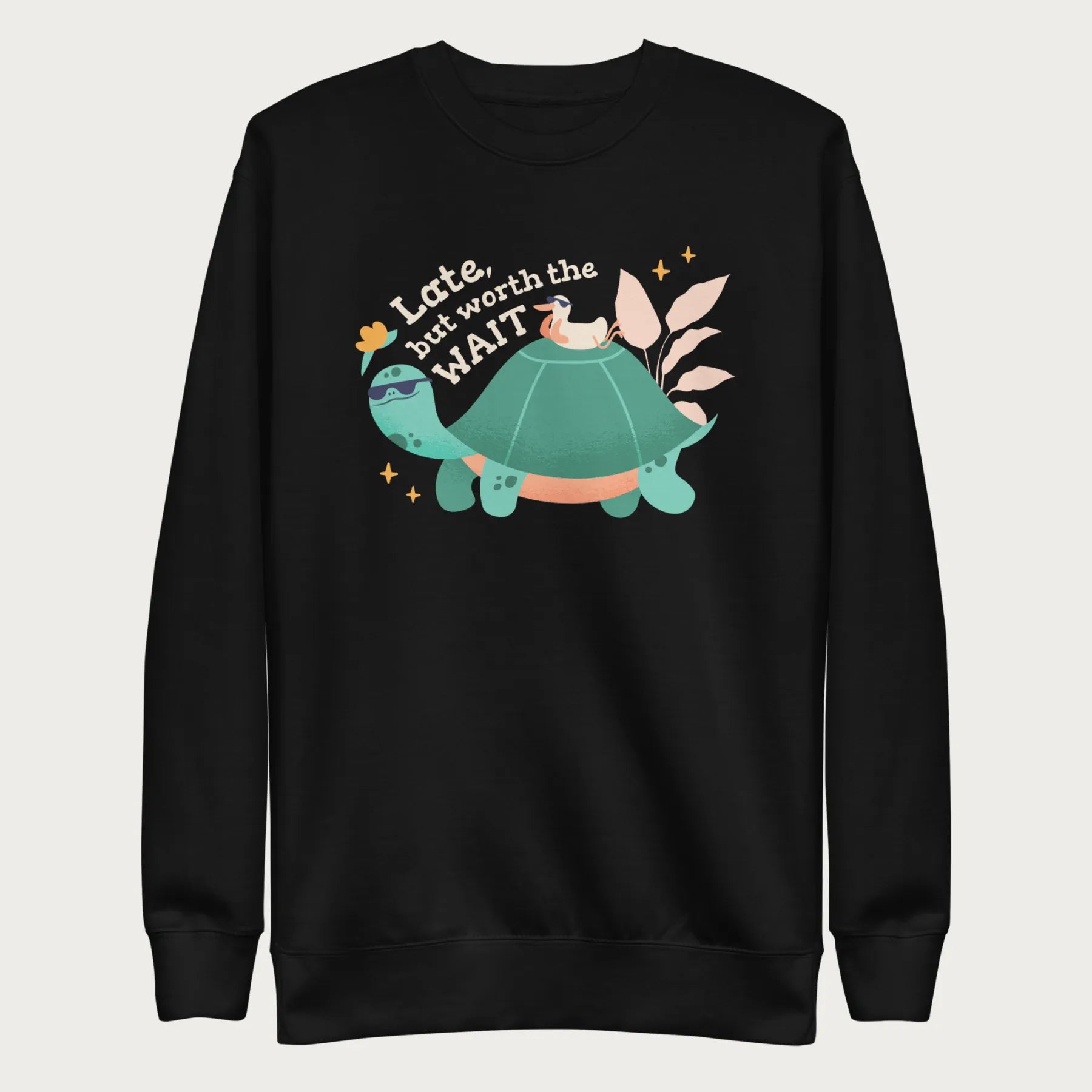 Black sweatshirt with a graphic of a turtle and bird wearing sunglasses with the phrase 'Late But Worth the Wait.'