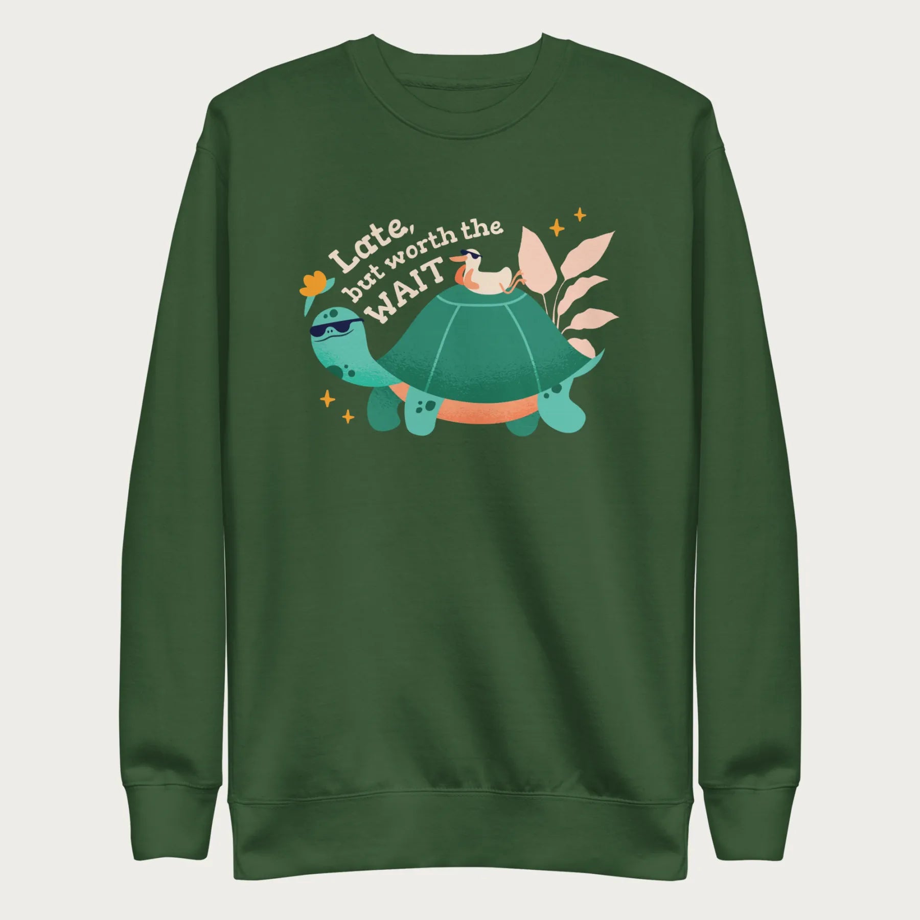 Forest green sweatshirt with a graphic of a turtle and bird wearing sunglasses with the phrase 'Late But Worth the Wait.'