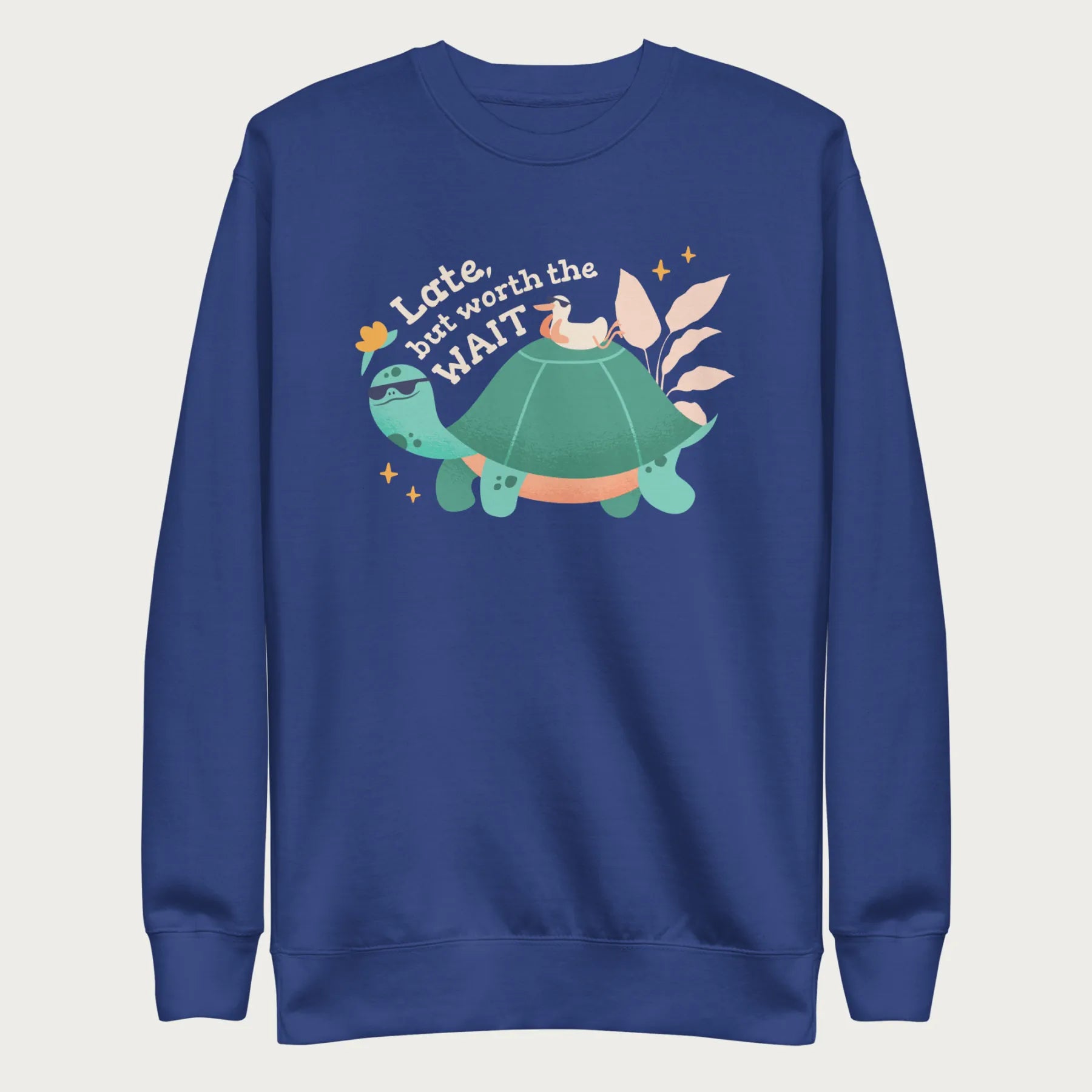 Royal blue sweatshirt with a graphic of a turtle and bird wearing sunglasses with the phrase 'Late But Worth the Wait.'