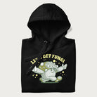 Folded black hoodie with a retro-inspired graphic of a mushroom mascot character and the text 'Let's Get Fungi'.