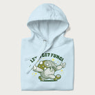Folded light blue hoodie with a retro-inspired graphic of a mushroom mascot character and the text 'Let's Get Fungi'.