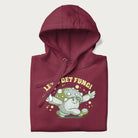 Folded maroon hoodie with a retro-inspired graphic of a mushroom mascot character and the text 'Let's Get Fungi'.